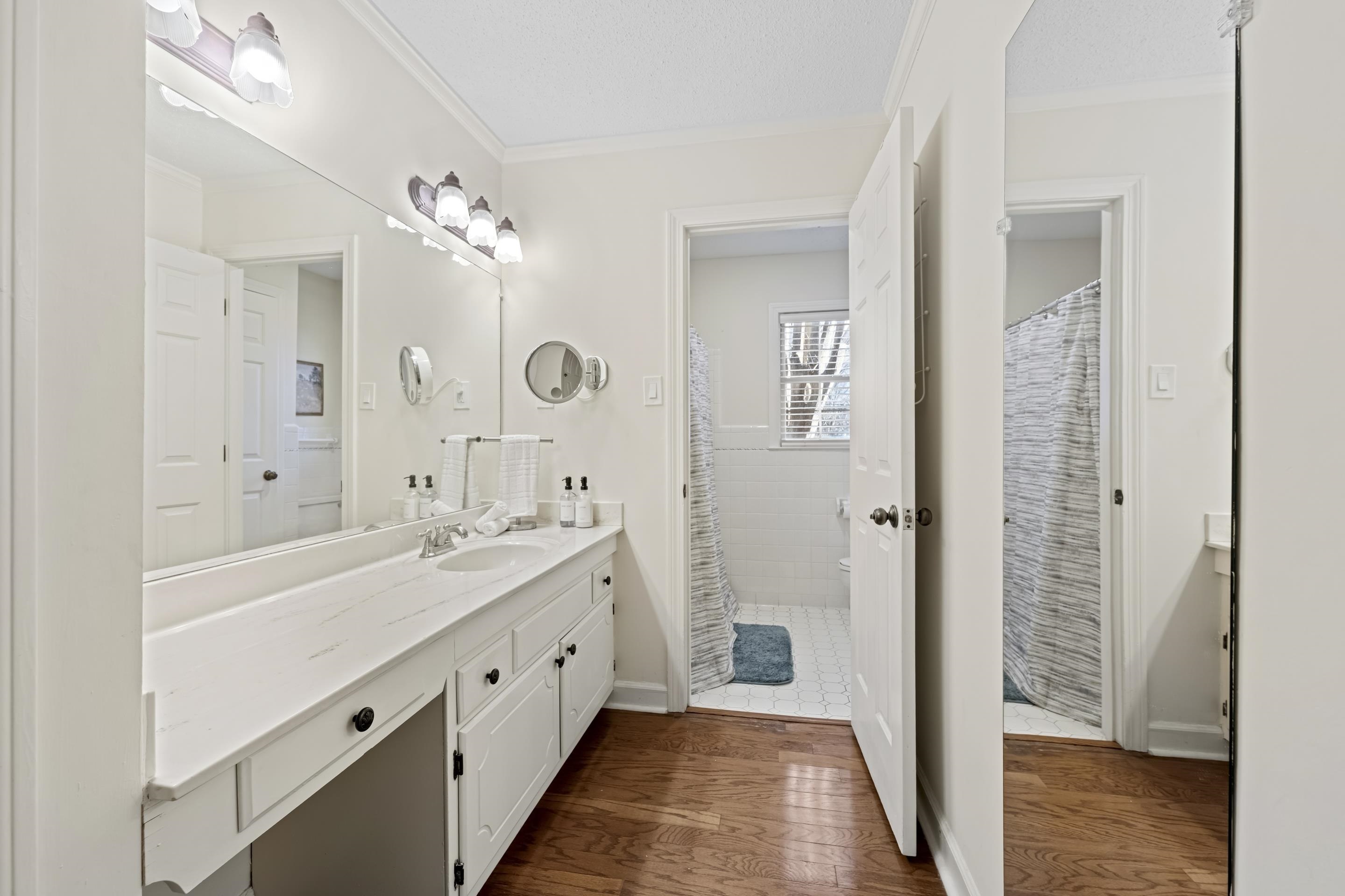1316 Kirby Road Memphis, TN 38120 - Photo 20 of 30 a spacious bathroom with a double vanity sink a mirror and a shower
