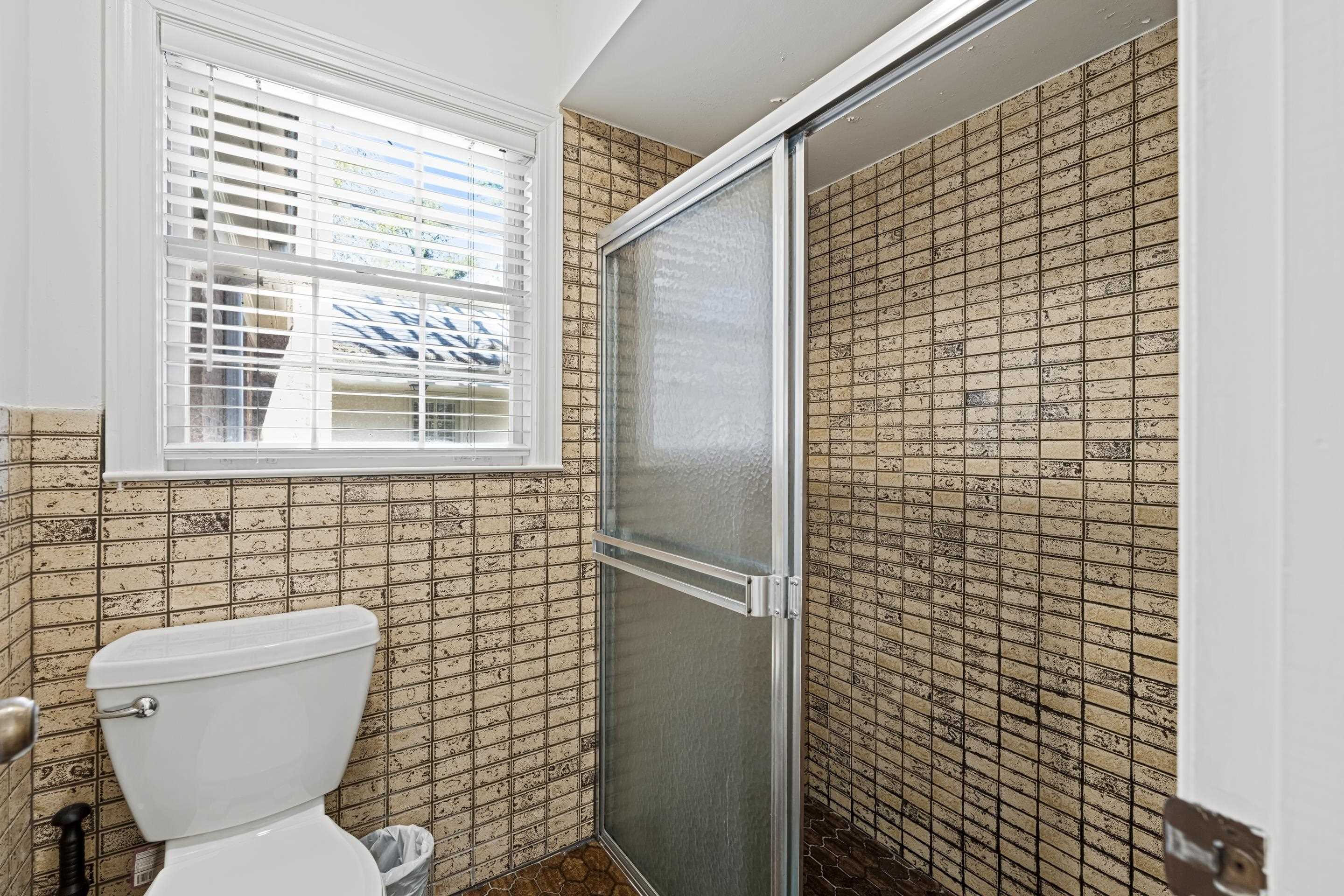 1316 Kirby Road Memphis, TN 38120 - Photo 26 of 30 a bathroom with a toilet a sink and a shower