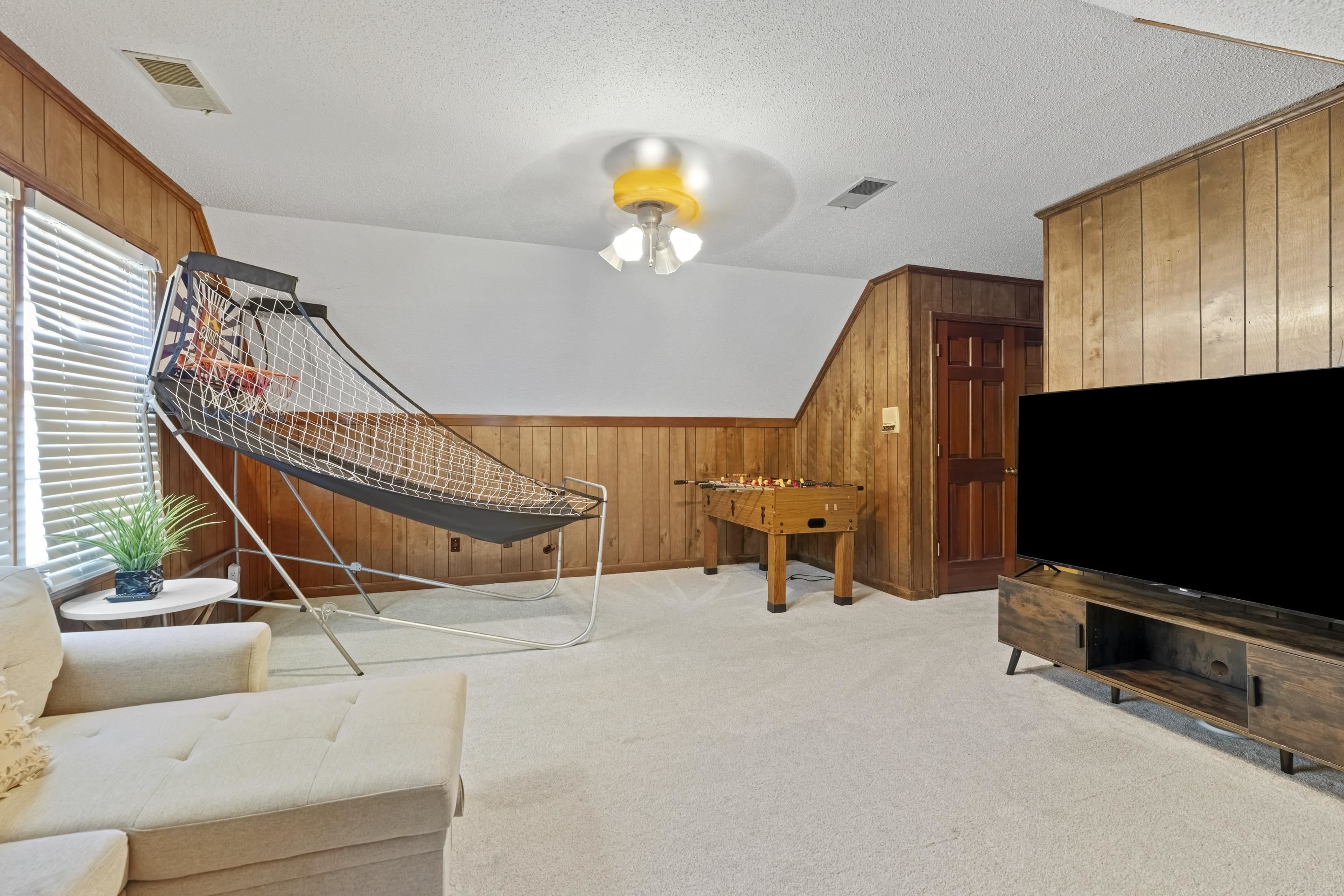 1316 Kirby Road Memphis, TN 38120 - Photo 28 of 30 a view of a livingroom with furniture and a flat screen tv
