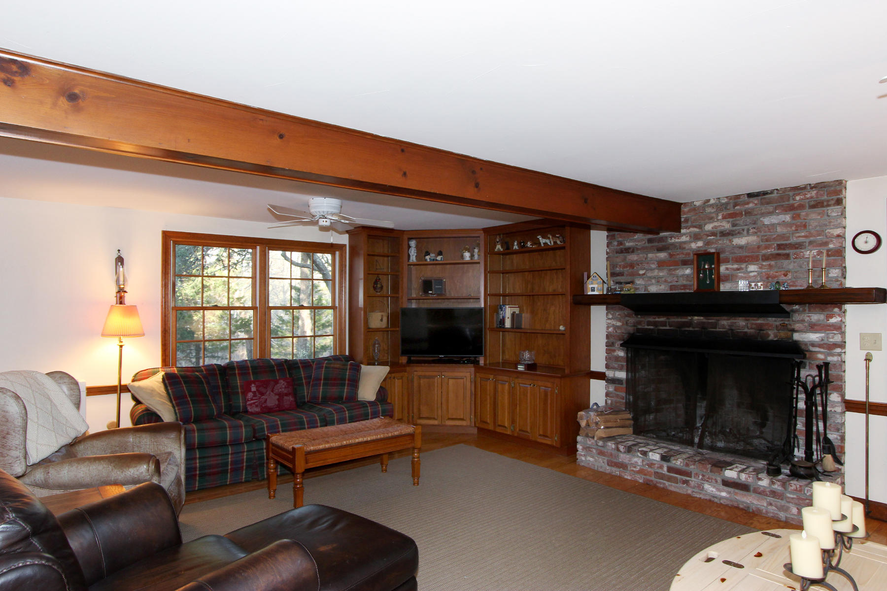 10 Highland Road Eastham, MA 02642 - Photo 7 of 31 a living room with furniture a flat screen tv and a fireplace