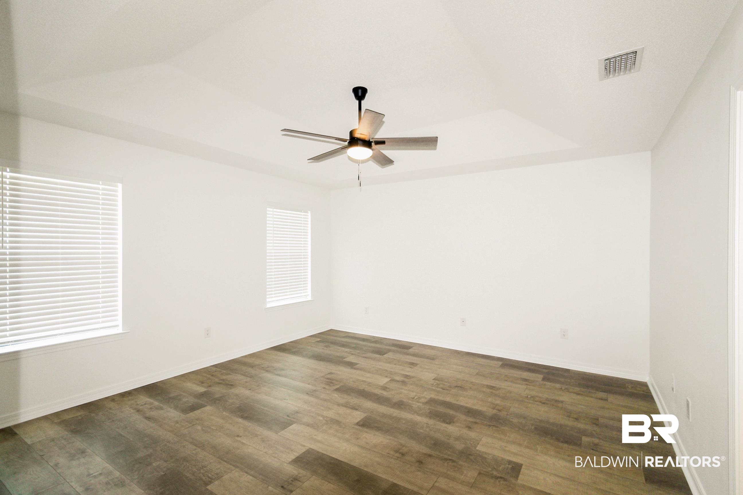 14750 Pawnee Court Foley, AL 36535 - Photo 22 of 34 Empty room with ceiling fan and wood finished floors