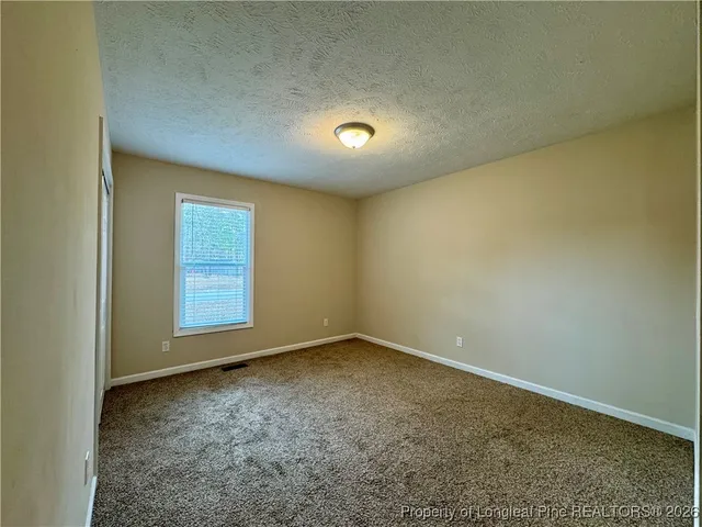 an empty room with closet area