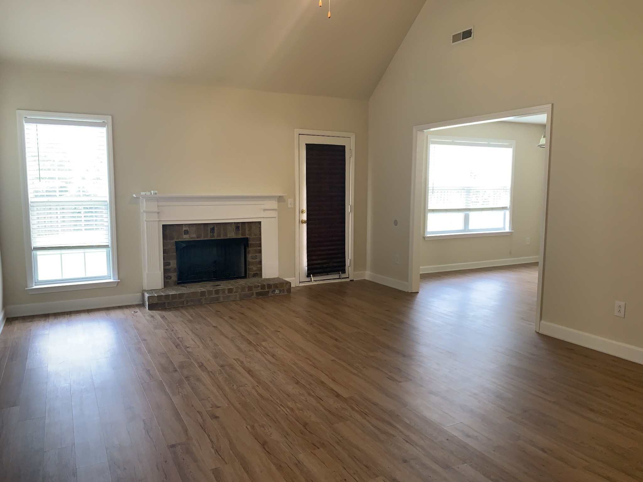 1036 Persimmon Drive Spring Hill, TN 37174 - Photo 2 of 12 an empty room with wooden floor fireplace and windows