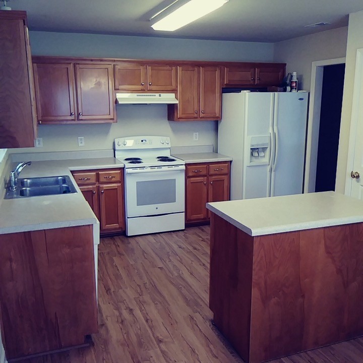 1036 Persimmon Drive Spring Hill, TN 37174 - Photo 3 of 12 a kitchen with wooden cabinets and stainless steel appliances