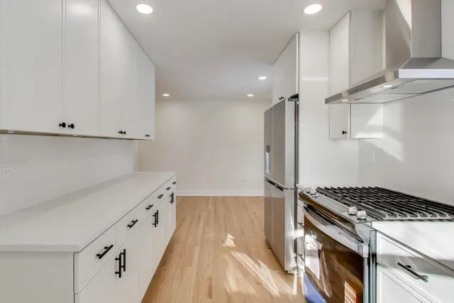 a kitchen with granite countertop a stove and a refrigerator