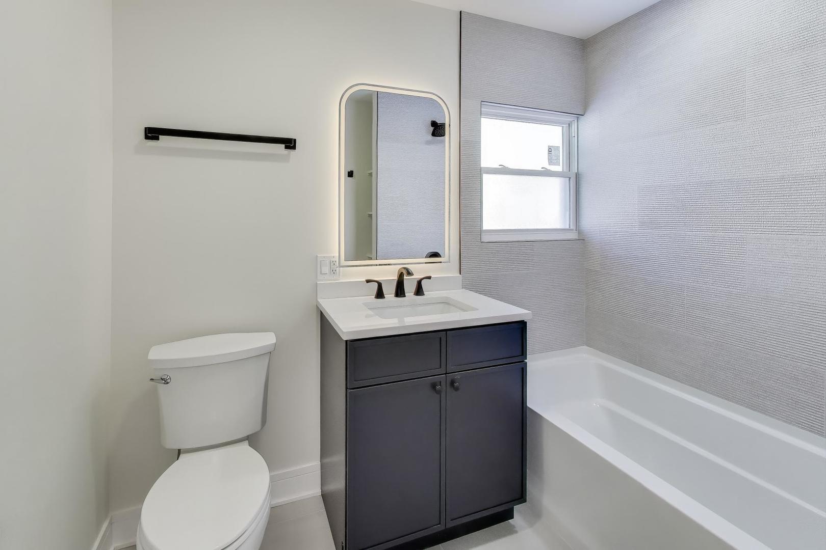 623 North Benton Street Palatine, IL 60067 - Photo 8 of 27 a bathroom with a toilet sink and mirror