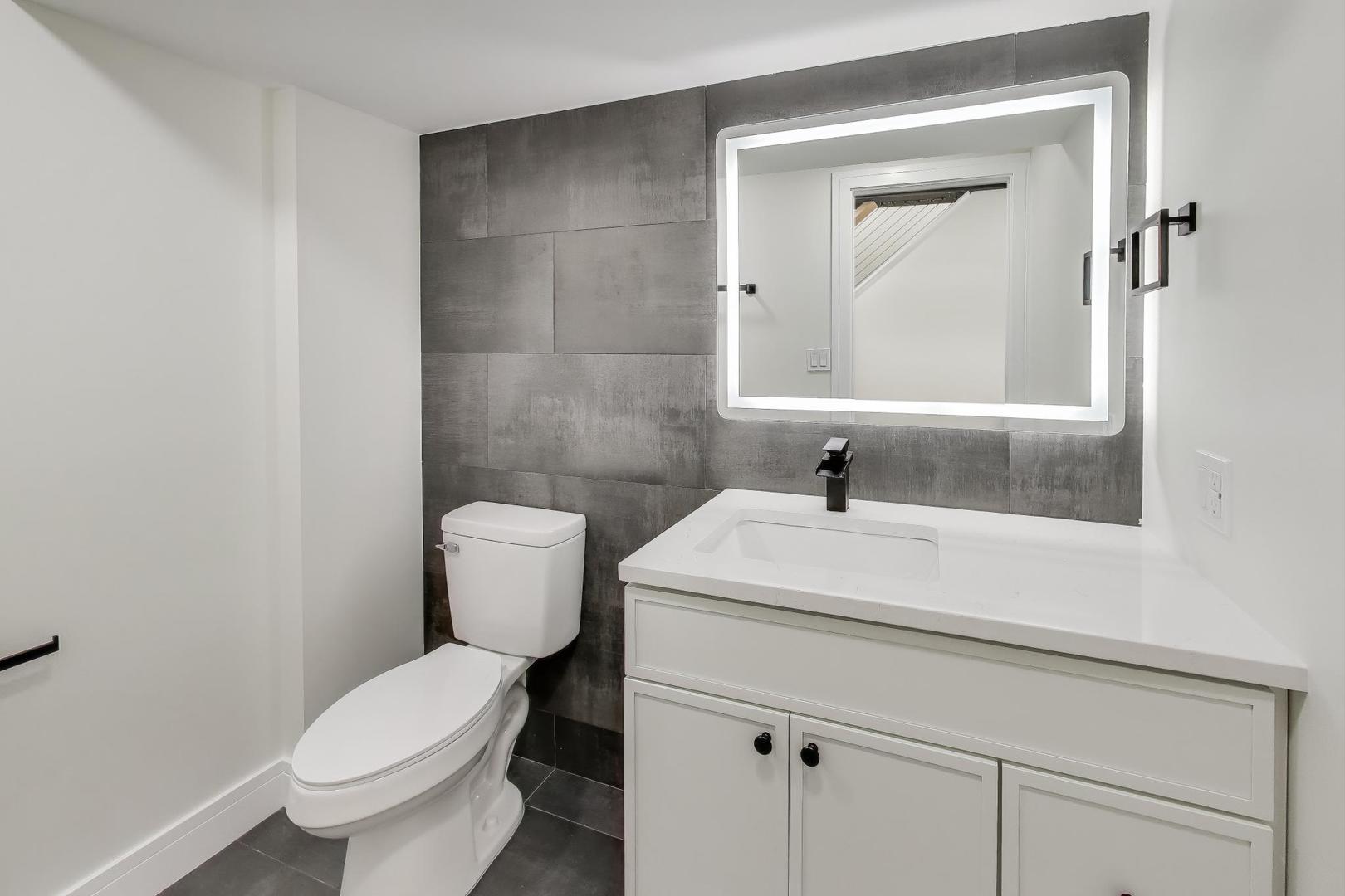 623 North Benton Street Palatine, IL 60067 - Photo 9 of 27 a bathroom with a sink a toilet and a mirror