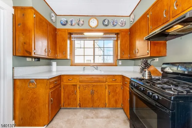 a kitchen with stainless steel appliances granite countertop a stove and a refrigerator