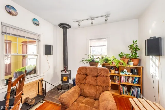 a living room with furniture a bookshelf and a large window