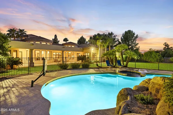 a front view of a house with a yard and potted plants
