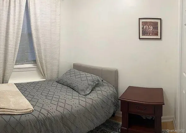 a bedroom with a bed and a desk