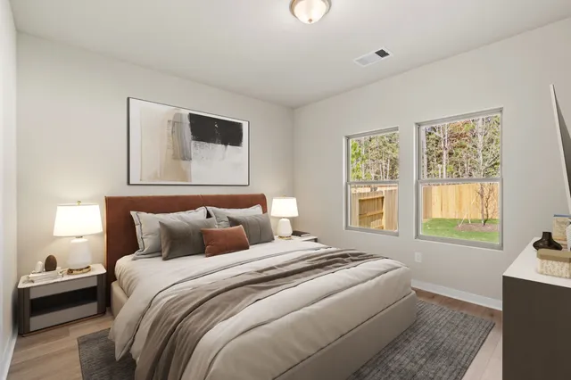 a bedroom with a bed and a window