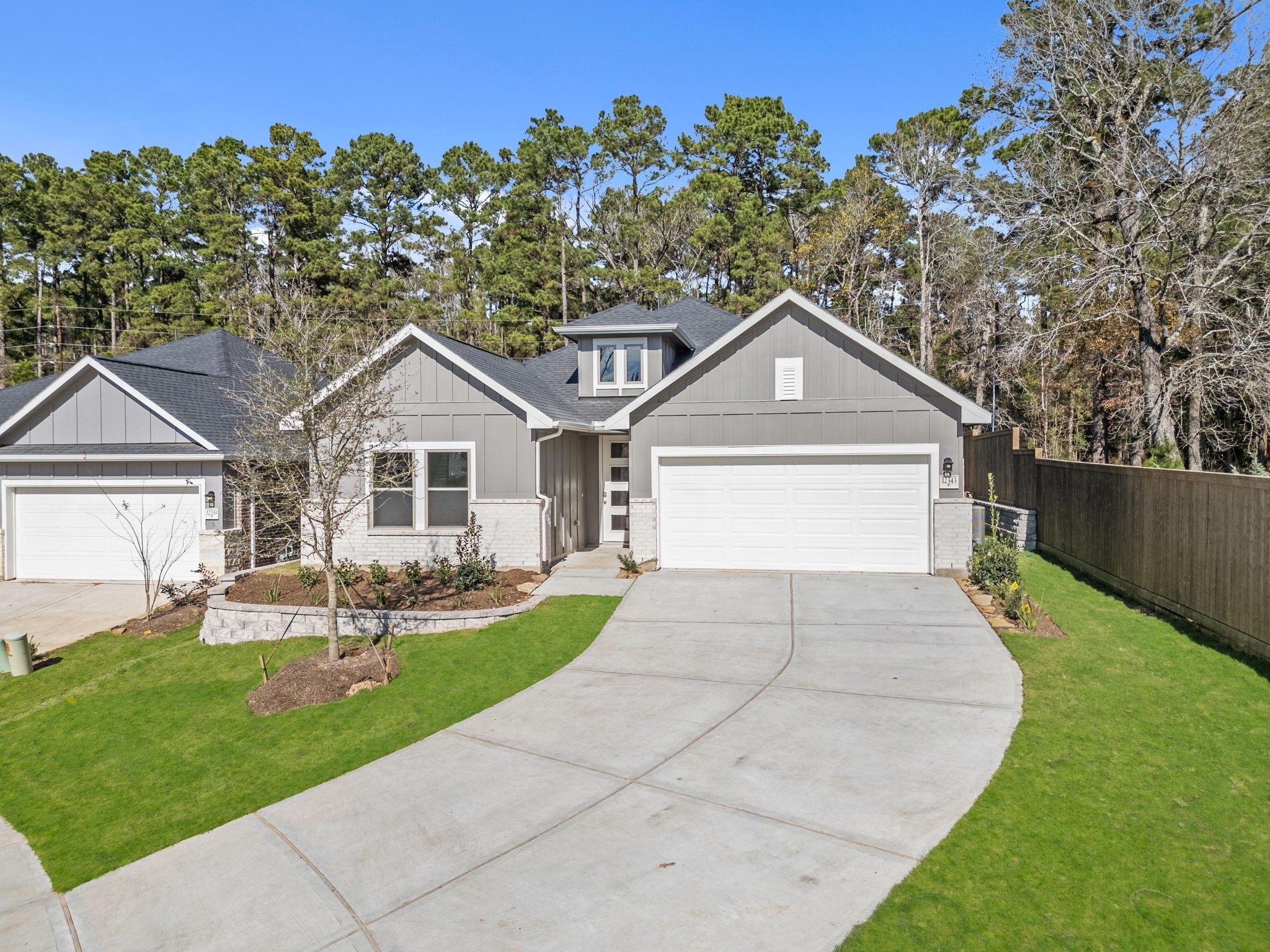12343 Ridge Top Drive Conroe, TX 77304 - Photo 27 of 32 a front view of a house with a yard and garage