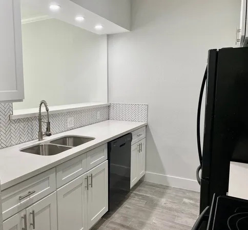 a kitchen with a sink and a refrigerator