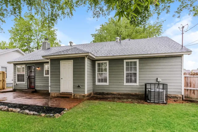 a front view of a house with a garden and yard