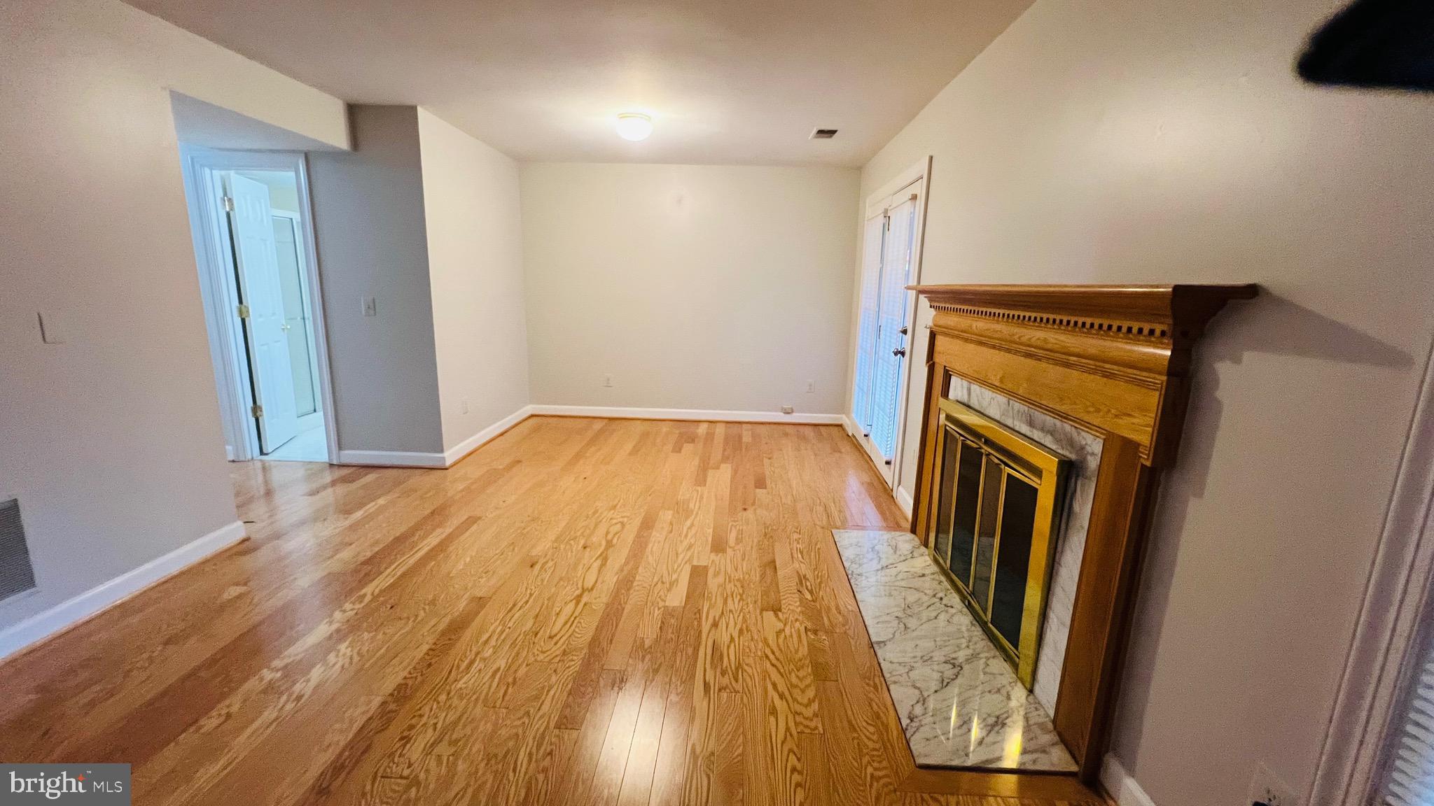 8035 Trevor Place Vienna, VA 22182 - Photo 13 of 48 a view of empty room with wooden floor