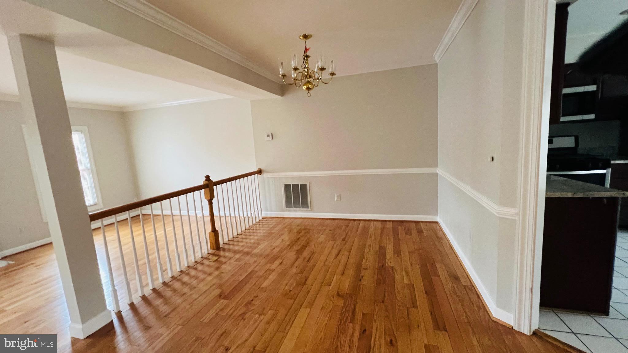 8035 Trevor Place Vienna, VA 22182 - Photo 22 of 48 a view of a hallway with wooden floor and staircase
