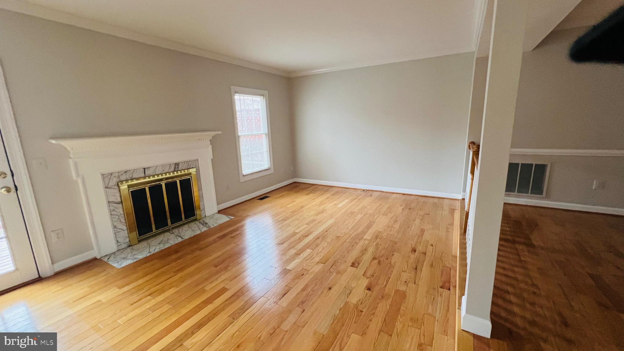 8035 Trevor Place Vienna, VA 22182 - Photo 24 of 48 wooden floor in an empty room with a fireplace