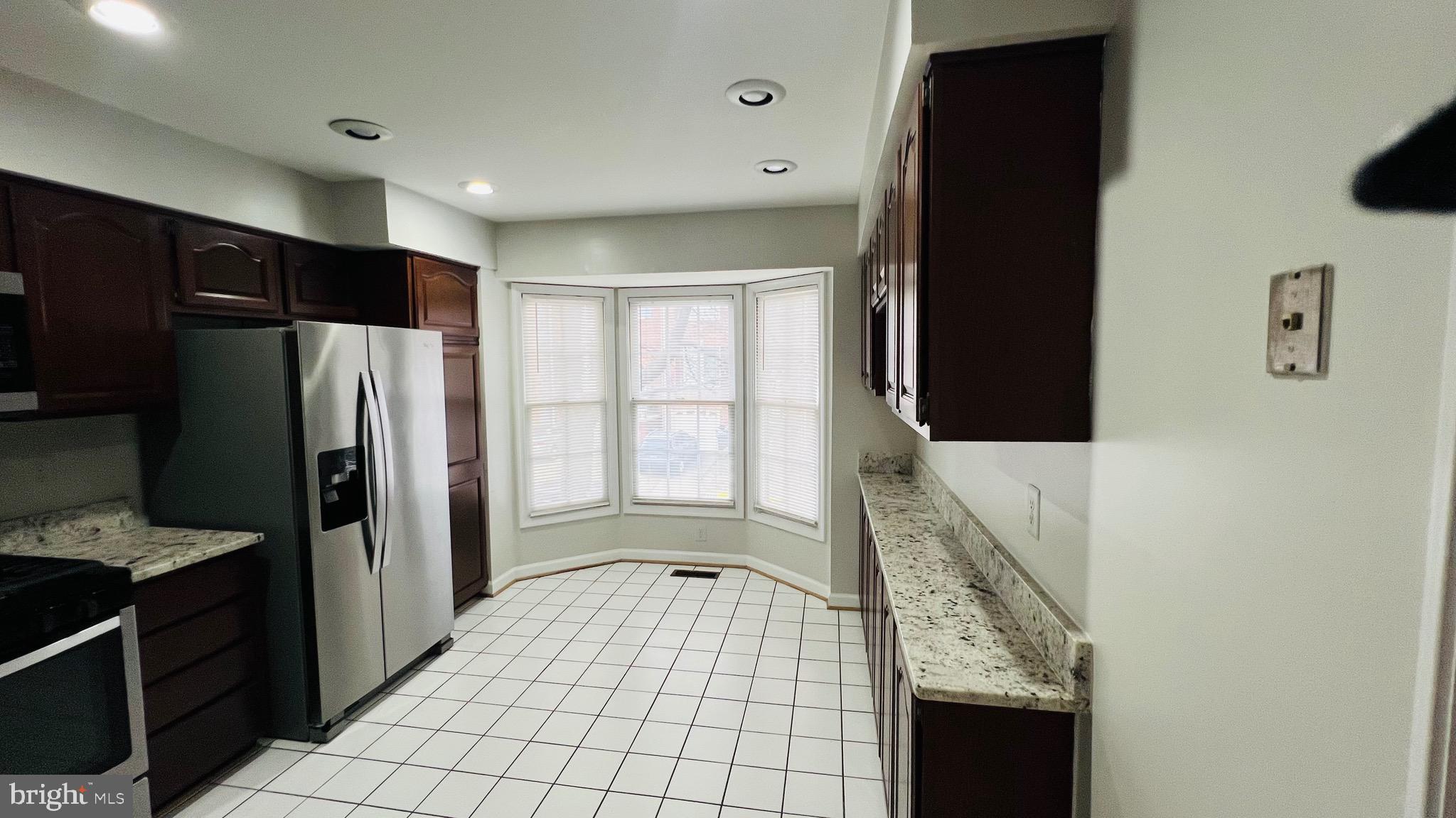 8035 Trevor Place Vienna, VA 22182 - Photo 32 of 48 a view of a kitchen with a sink and refrigerator