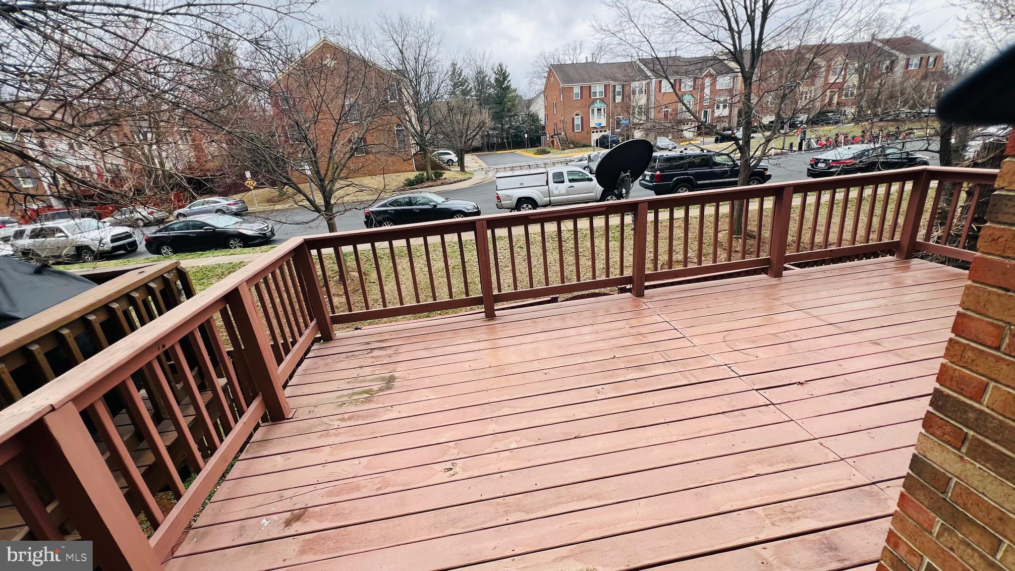 8035 Trevor Place Vienna, VA 22182 - Photo 34 of 48 a view of balcony with wooden floor and fence