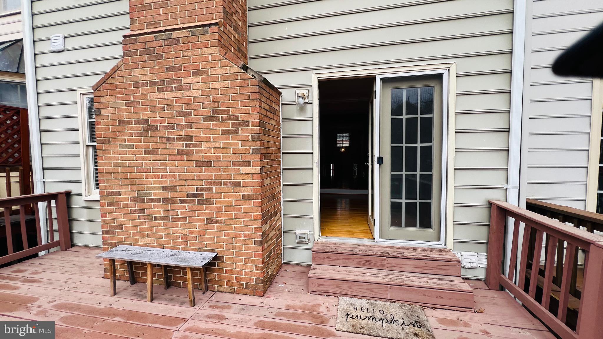 8035 Trevor Place Vienna, VA 22182 - Photo 37 of 48 a view of a patio with table and chairs and wooden floor