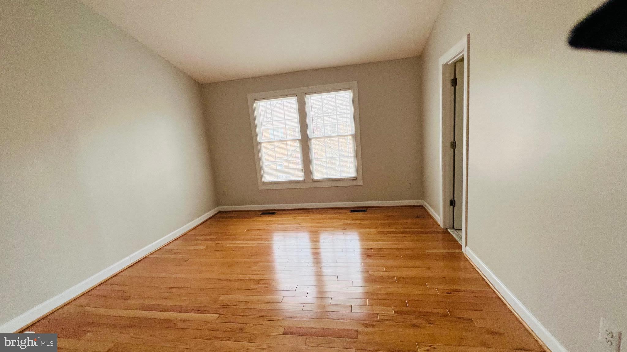 8035 Trevor Place Vienna, VA 22182 - Photo 42 of 48 a view of empty room with wooden floor and fan
