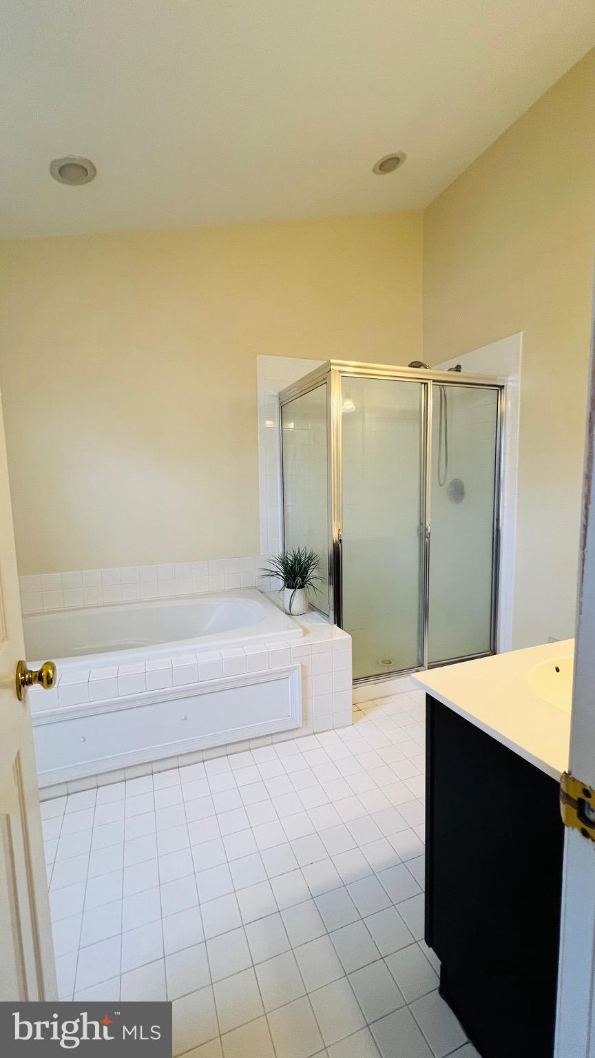 8035 Trevor Place Vienna, VA 22182 - Photo 44 of 48 a spacious bathroom with a bathtub and a shower