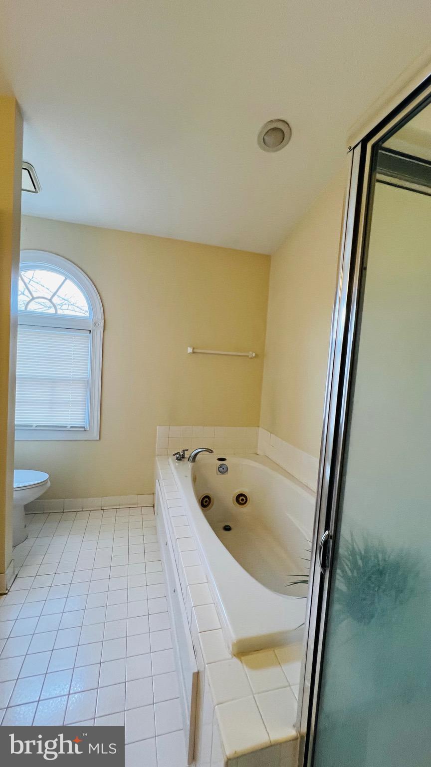 8035 Trevor Place Vienna, VA 22182 - Photo 46 of 48 a bathroom with a tub and a shower