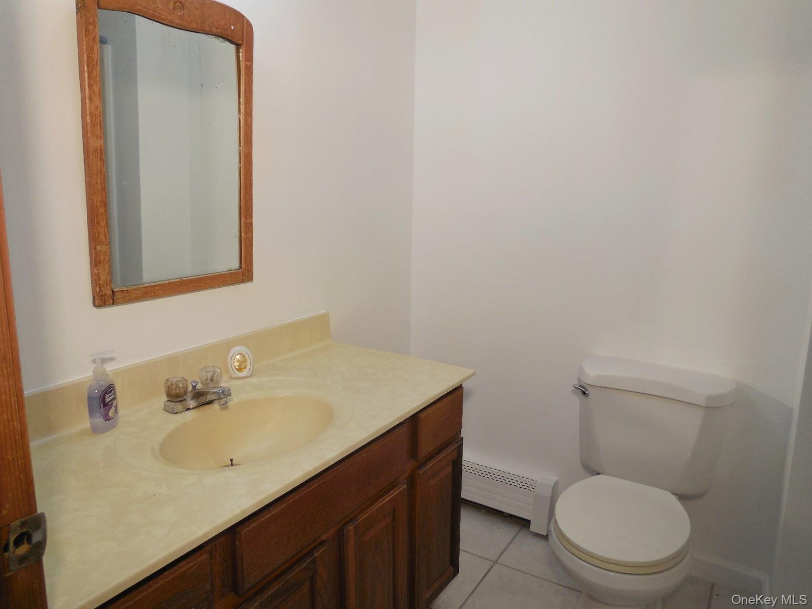 617 Burlingham Road Bloomingburg, NY 12721 - Photo 12 of 39 Main bathroom upstairs with tiled floor and tub.