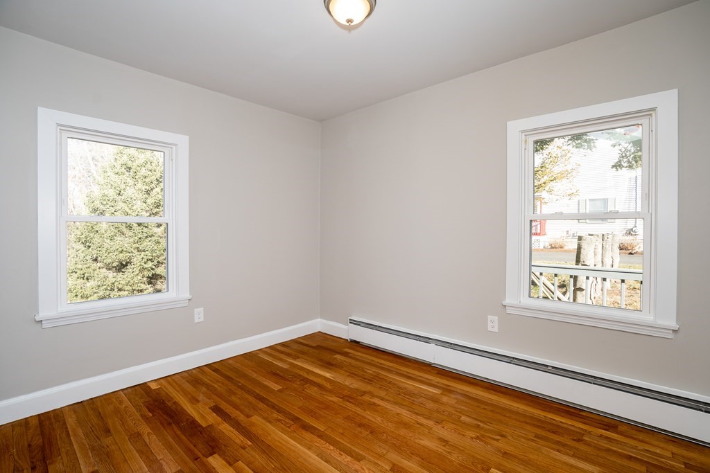 252 Old Warren Road Palmer, MA 01069 - Photo 17 of 29 a view of an empty room with wooden floor and a window