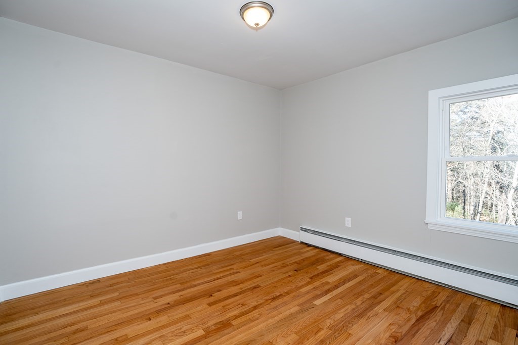 252 Old Warren Road Palmer, MA 01069 - Photo 19 of 29 a view of empty room with wooden floor and fan