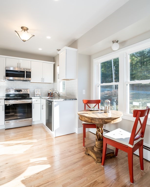 252 Old Warren Road Palmer, MA 01069 - Photo 3 of 29 a dining room with a table chairs and kitchen view
