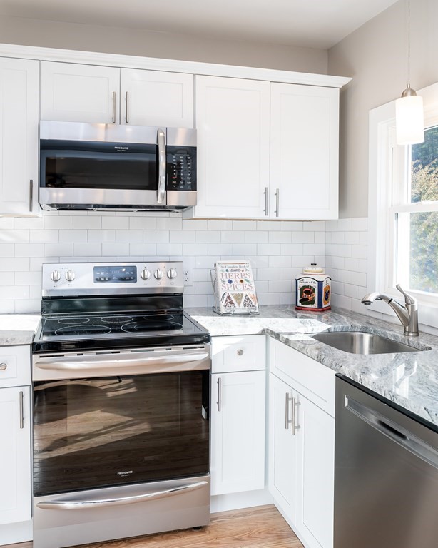 252 Old Warren Road Palmer, MA 01069 - Photo 5 of 29 a kitchen with stainless steel appliances granite countertop a stove microwave and sink