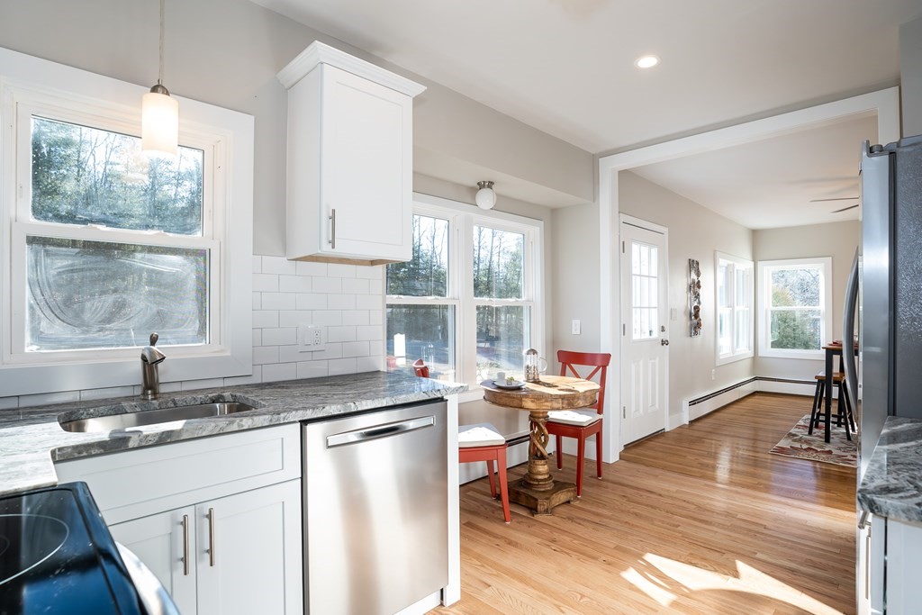 252 Old Warren Road Palmer, MA 01069 - Photo 7 of 29 a kitchen with a sink stove and cabinets