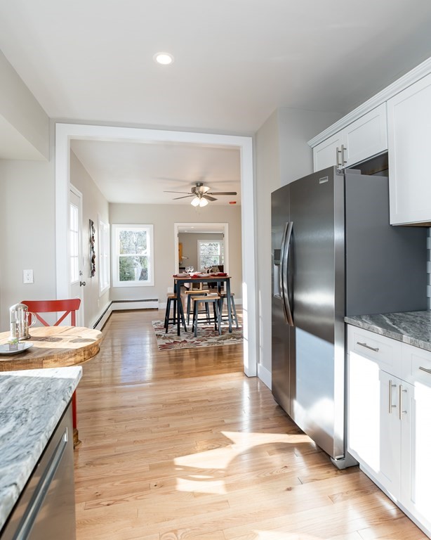 252 Old Warren Road Palmer, MA 01069 - Photo 8 of 29 a kitchen with stainless steel appliances granite countertop a refrigerator a stove and a wooden floors