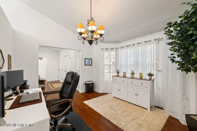 a view of a workspace with furniture and a kitchen