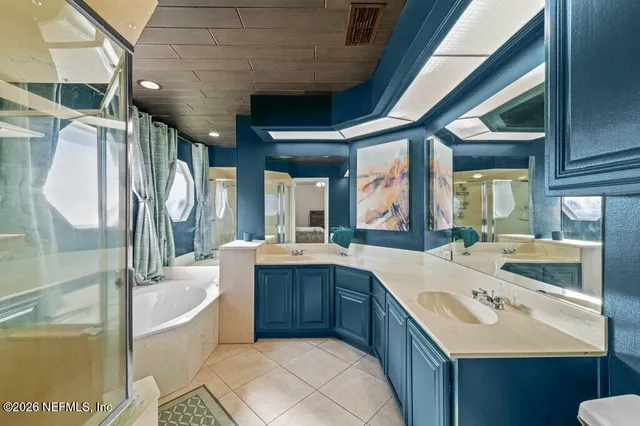 a large white kitchen with a large window