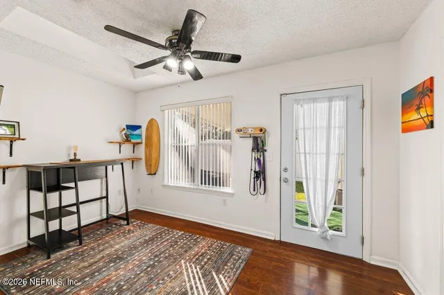 a view of a livingroom with furniture and hardwood floor