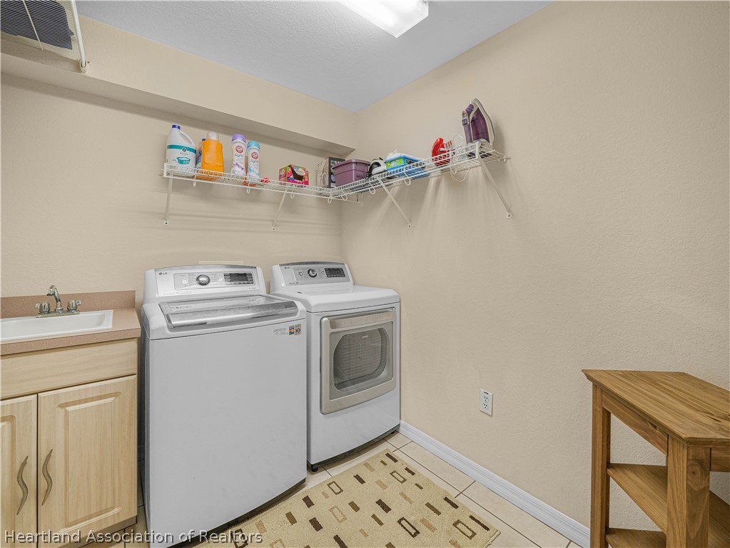 5721 Golden Road Sebring, FL 33875 - Photo 19 of 42 Interior Laundry Room - washer, dryer & built-in laundry sink