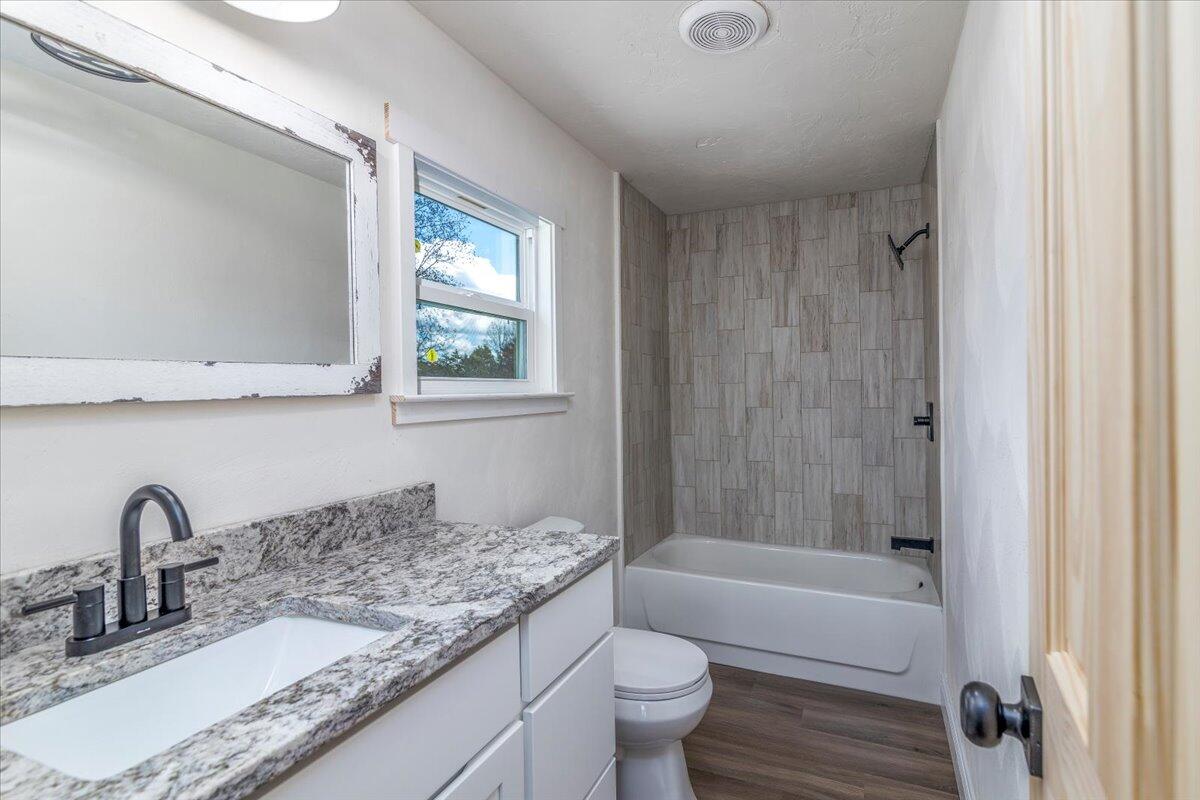 36 Nutmeg Lane Penhook, VA 24137 - Photo 19 of 37 a bathroom with a granite countertop sink toilet and a bathtub
