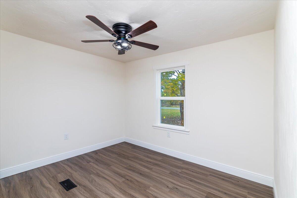 36 Nutmeg Lane Penhook, VA 24137 - Photo 22 of 37 an empty room with wooden floor fan and windows