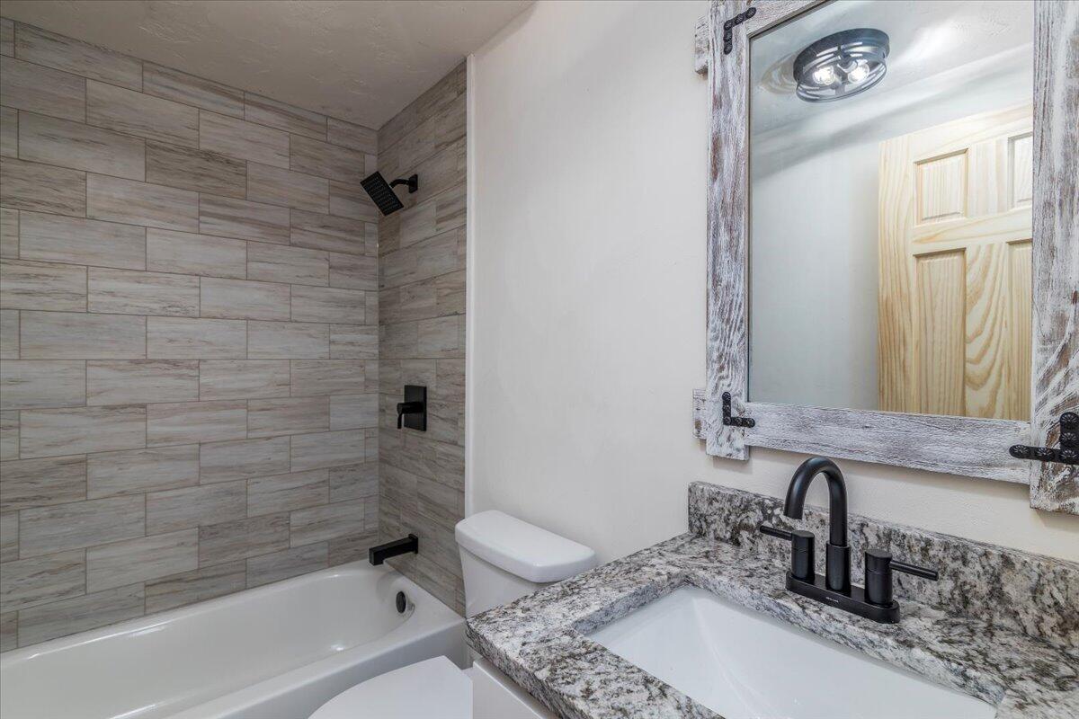 36 Nutmeg Lane Penhook, VA 24137 - Photo 26 of 37 a bathroom with a granite countertop sink a toilet and bathtub