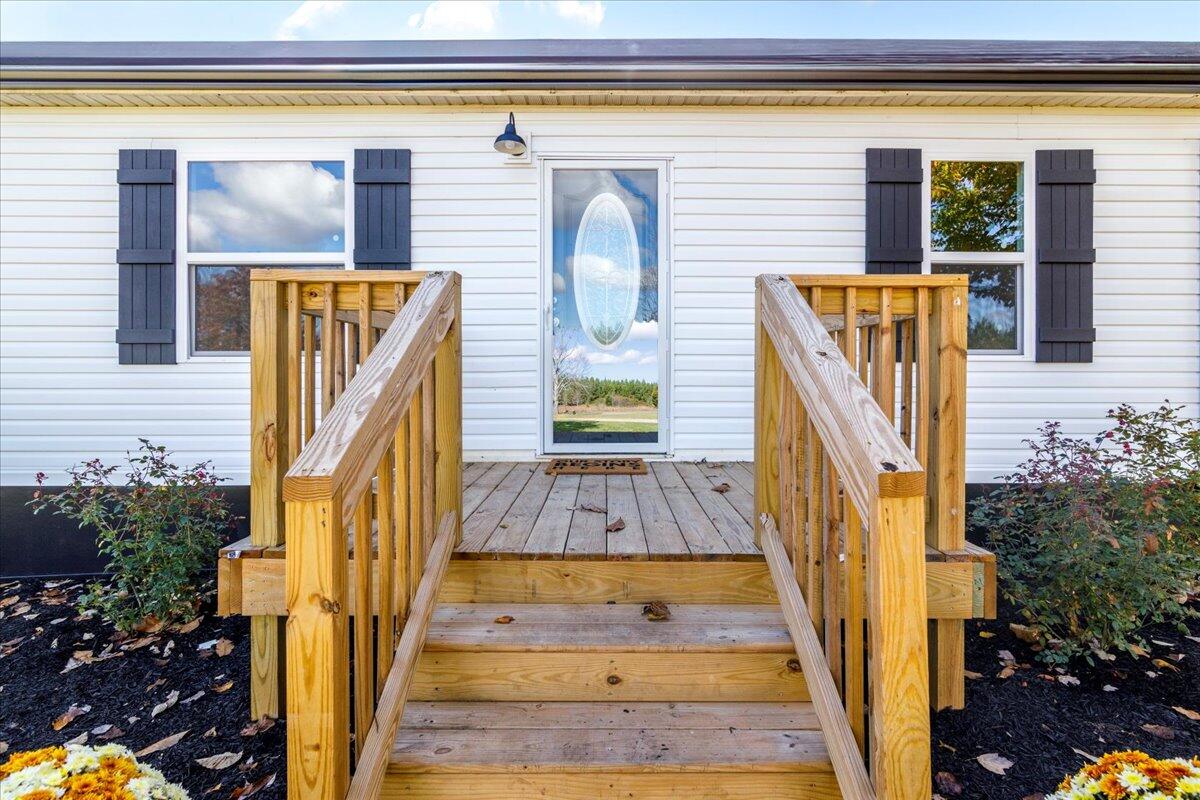 36 Nutmeg Lane Penhook, VA 24137 - Photo 3 of 37 a view of front door of house with wooden floor and potted plants