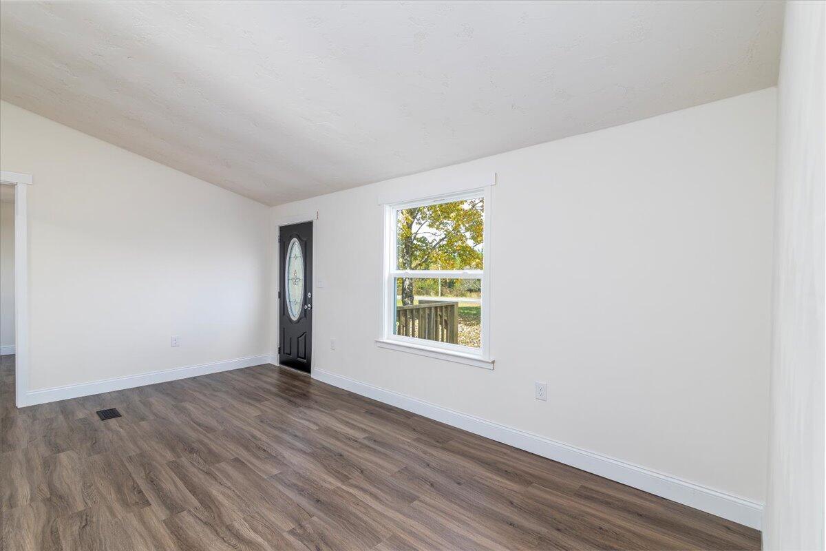 36 Nutmeg Lane Penhook, VA 24137 - Photo 6 of 37 an empty room with wooden floor and windows