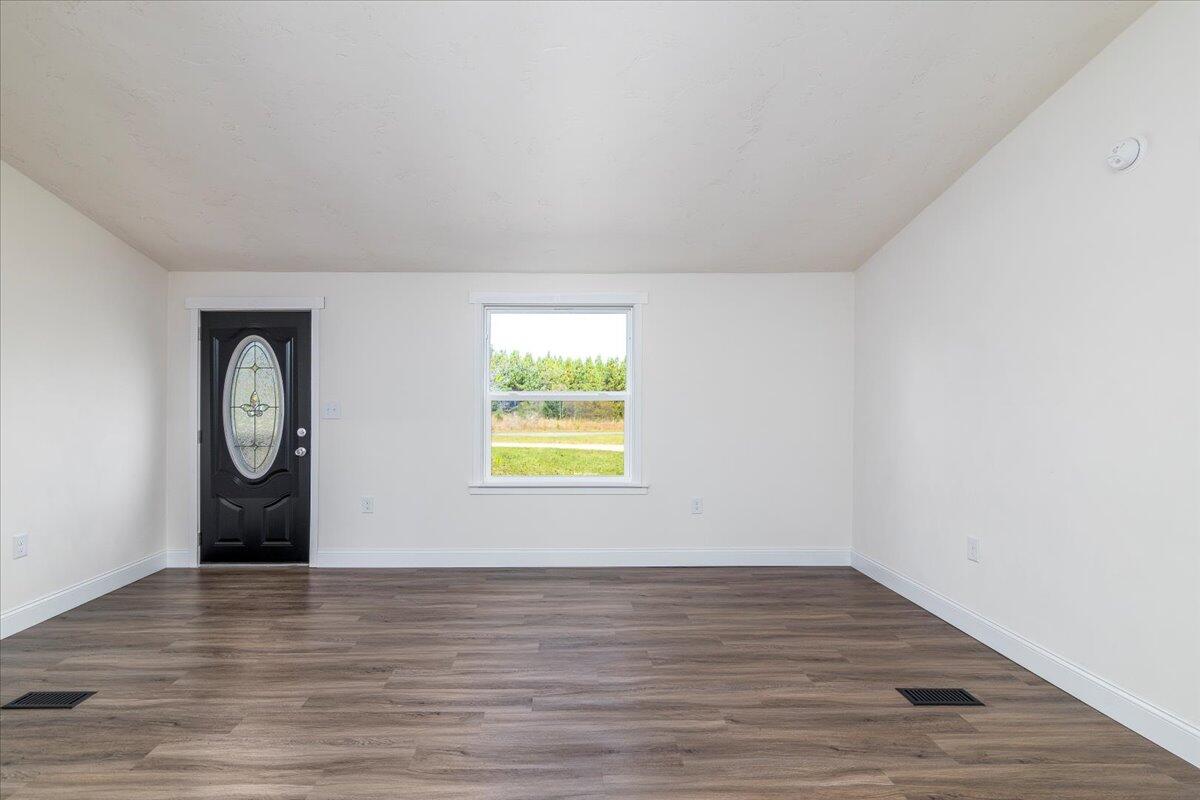 36 Nutmeg Lane Penhook, VA 24137 - Photo 8 of 37 a view of an empty room with wooden floor and a window