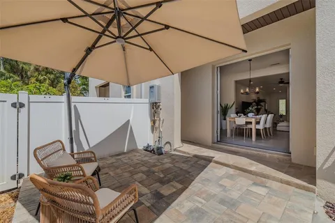 a patio with a table and chairs and a umbrella