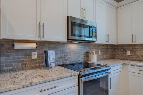 a kitchen with a stove microwave and sink