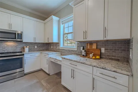 a kitchen with sink cabinets and stainless steel appliances
