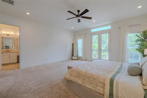 a bedroom with a large bed and a chandelier