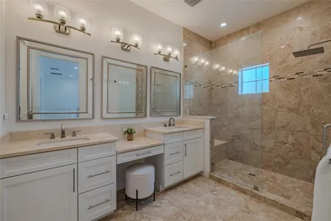 a bathroom with a double vanity sink mirror and shower